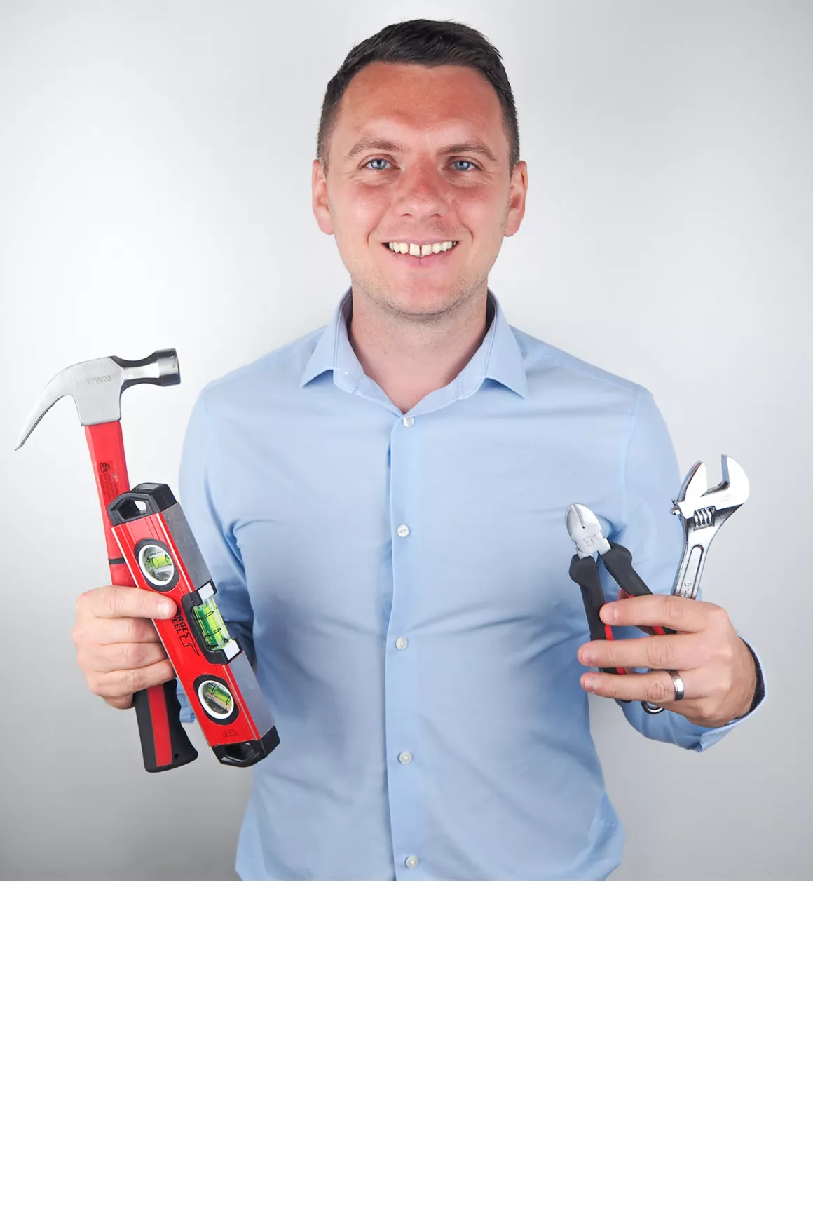 Mark Everitt (Team Leader) wearing blue shirt and holding DIY drops, photo taken at Prime Appointments HQ, with white background