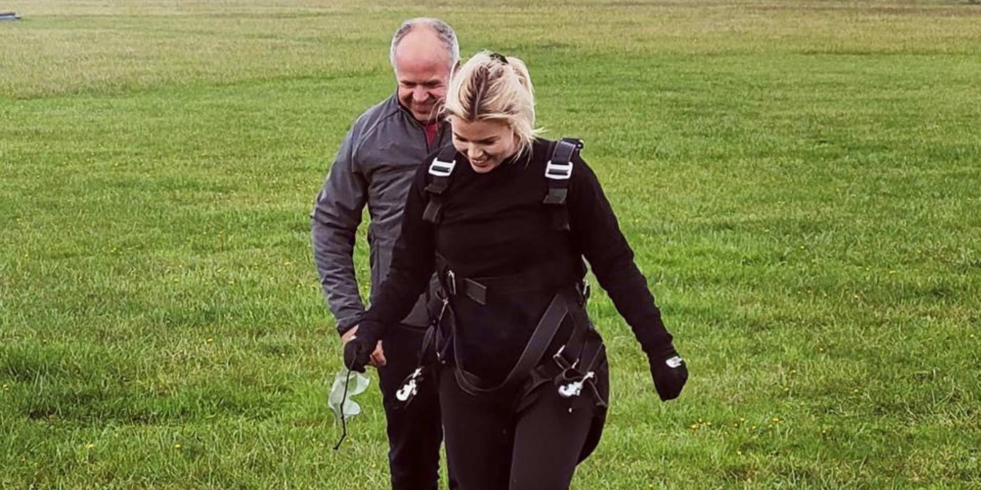 Katie Holmes and Peter Holmes walking together after completing sky dive for Alzheimers